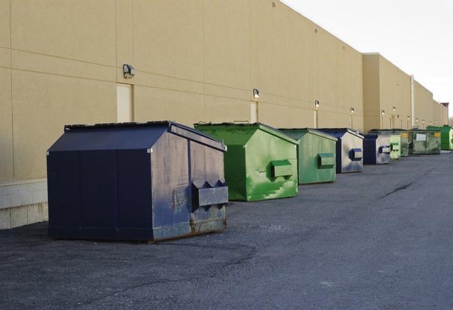 a construction worker moves construction materials near a dumpster in Hidden Hills, CA